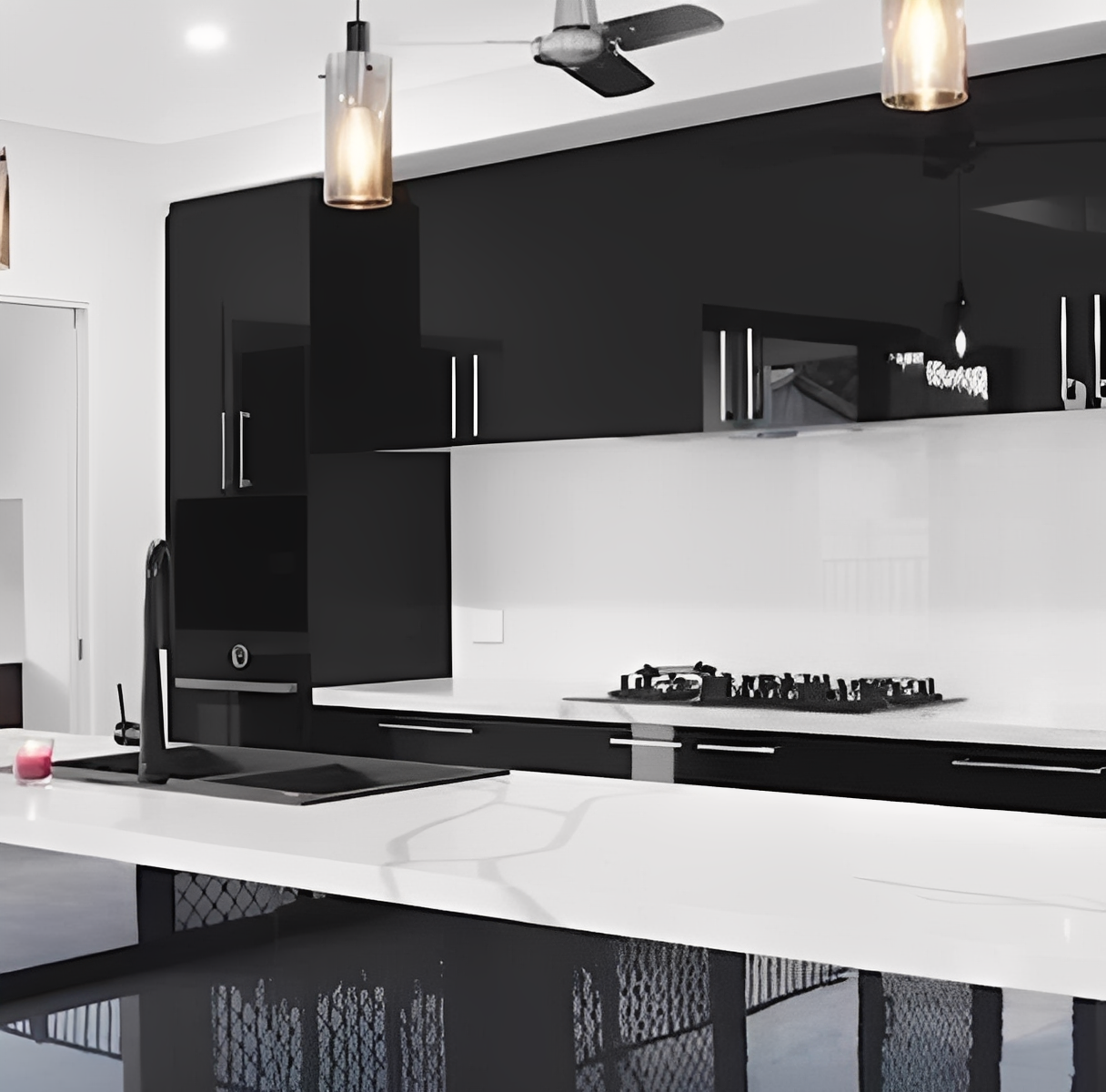 Sleek kitchen featuring black cabinets and fixtures